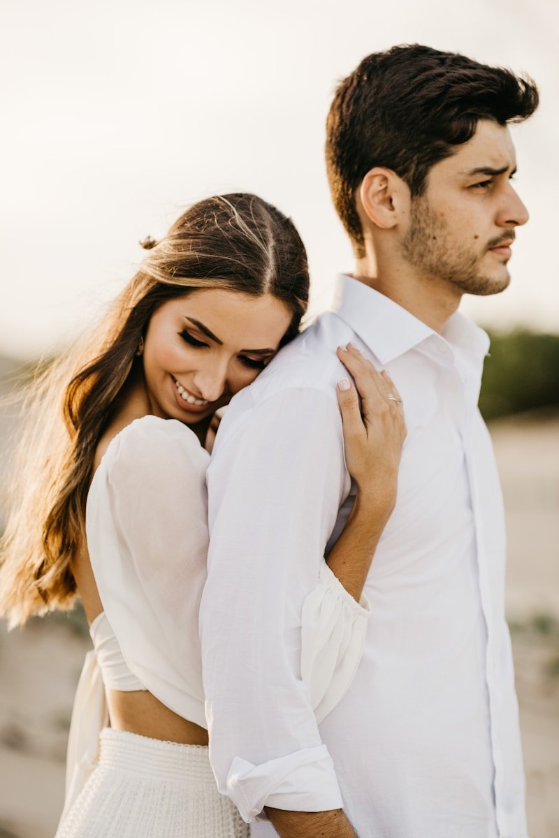 Photo by Jonathan Borba man in white long sleeve shirt hugging woman in white long sleeve shirt